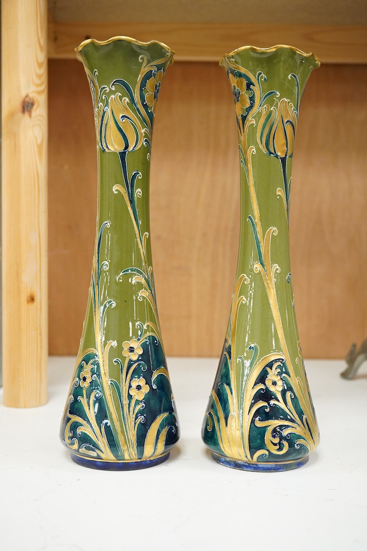 A pair of early 20th century Moorcroft MacIntrye Florian green and gold vases, signed and stamped to the bases, 29cm high